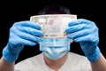 500 hryvnia Ukrainian currency bill in hands in medical gloves.