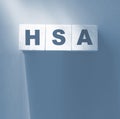 HSA abbreviation on wooden cubes on red. Concept. Health Savings Account.