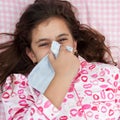 Hspanic girl sick with the flu and sneezing