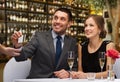 Hsppy couple paying with credit card at restaurant