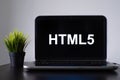HTML5 programming language. Programming training, the concept of computer courses. Laptop on the table
