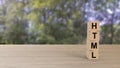 HTML word wooden cubes on table vertical over blur background with trees green sky, mock up, template, banner with copy space for Royalty Free Stock Photo