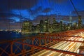 Brooklyn Bridge with fast moving traffic on the road at Twilight with Lower Manhattan in the background, New York, USA America Royalty Free Stock Photo