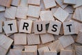 Wooden blocks with letters spelling trust