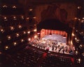 performers of the Symphony Orchestra on the stage of a classical theater