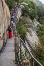 HUA SHAN, CHINA - AUGUST 4, 2018: People at a narrow path at the Hua Shan mountain in Shaanxi province, Chi