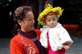 Huang Long Xi, China: Baby with Floral Wreath