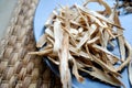 Huang Qi Astragalus root sliced and dried on a plate.