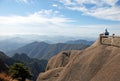 Huangshan Mountain in Anhui Province, China. Tourist taking in the panoramic view from Turtle Peak