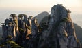 Huangshan Mountain in Anhui Province, China. View at sunrise from Dawn Pavilion with a rocky outcrop and pine trees Royalty Free Stock Photo