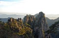 Huangshan Mountain in Anhui Province, China. View at sunrise from Dawn Pavilion viewpoint with a rocky outcrop and pine trees Royalty Free Stock Photo