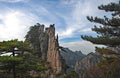 Huangshan Mountain in Anhui Province, China. View of a rugged peak with pine trees near Fairy Walking Bridge Royalty Free Stock Photo