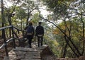 Huangshan Mountain in Anhui Province, China. Walkers on a path through the forest near Fairy Walking Bridge Royalty Free Stock Photo