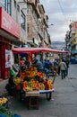 Huaraz, Peru, July 28, 2014: Colorful tropical fruit stand on a busy street between buildings Royalty Free Stock Photo