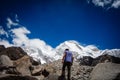 Huaraz/Peru - Oct.09.19: hiker admires the snowy peak after climbing the mountain