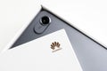 Huawei label on a fragment of a white original box. White background with the unpacking of a gadget with a built-in camera. Photo