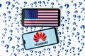 HUAWEI logo and American flag on the smartphones and a lot of cut paper question marks around. The conceptual photo about future o Royalty Free Stock Photo