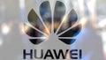 Huawei logo on a glass against blurred crowd on the steet. Editorial 3D rendering