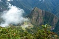 Huayna Picchu, or Wayna Pikchu, mountain in clouds rises over Machu Picchu Inca citadel, lost city of the Incas Royalty Free Stock Photo