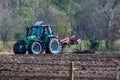 Hude, Germany April 6th, 2020: A tractor stands with his implement on a freshly cleared field