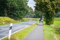 Hude,  Germany, September, 8, 2019: an elderly couple driving on a country road with the bike Royalty Free Stock Photo