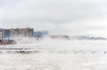 Hudson river in Winter with Misty Edgewater Cityscape in Background.