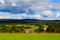 Hudson Valley skyline with farm land and meadows on a cloud filled summer day.