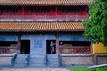 Hue / Vietnam, 17/11/2017: Couple standing inside a traditional house with ornamental tiled roof in the Citadel of Hue, Vietnam