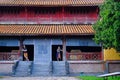 Hue / Vietnam, 17/11/2017: Couple standing inside a traditional house with ornamental tiled roof in the Citadel of Hue, Vietnam