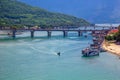 Beautiful aerial view with bridge, boats and mountains under a dramatic sky Royalty Free Stock Photo