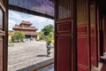 Hue, Vietnam - June 2019: view over traditional Vietnamese temple through open decorated entrance doors Royalty Free Stock Photo