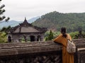 Young woman admiring scenery on the grounds of Khai Ding Tomb, one of Imperial Tombs of Hue