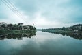 Hue, Vietnam. Pond in city center city at background. Two-storey mansions on the lake. clouds reflected in water