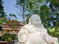 Hue, Vietnam - September 13 2017: Close up of a huge white budha with a beautiful ancient temple behind, located in Hue