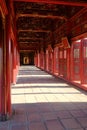 Hue / Vietnam, 17/11/2017: Woman passing through a red ornamental pavillion in the Citadel complex in Hue, Vietnam