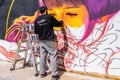 Huelva, Spain - April 24, 2022: The urban artist Victor Romero Konestilo is creating a workart in live of Graffiti, on the Royalty Free Stock Photo