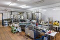 Bottling and labeling machine inside of a modern olive oil mill. Extra virgin olive oil factory