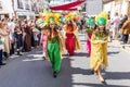 Beautiful exotic young girls, dressing colorful period costumes, in the parade of Medieval