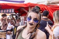 Beautiful young woman dressed and made up in exotic period costume in the parade of Medieval