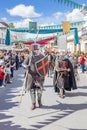 Knight dressing a metallic armor and a cavalry lance or jousting lance is parading in the Medieval