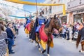 Man dressed in period costume and riding a horse is parading in the Medieval Discovery Fair in