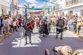 Men dressing as a medieval knight with metallic armor is mading a performance in the parade of