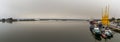 Panorama of a calm Rio Tinto River with harbor cranes and Guardia Civil police boats in the harbor of Huelva