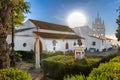 Huelva, Spain - September 8, 2020: View of Sanctuary Virgen de la Cinta from Gardens, backlighted with sun flares, patron virgin