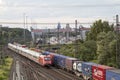 Huerth, NRW, Germany, 06 27 2020, cargo train before skyline of cologne, container station cologne Eifeltor, passenger train
