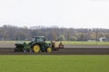 Huerth, NRW, Germany, 04 17 2021, tractor with seeding machine on a field