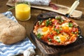 Huevos a la Flamenca or Flamenco Eggs. Eggs poached in tomato sauce.
