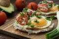 Huevos rancheros tostadas with avocado salsa