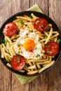 Huevos rotos con chorizo fried egg with fries and sausage close-up in a pan. vertical top view Royalty Free Stock Photo