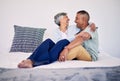 Hug, bedroom and laughing senior couple bonding, talking and enjoy quality time, funny conversation or trust. Morning Royalty Free Stock Photo